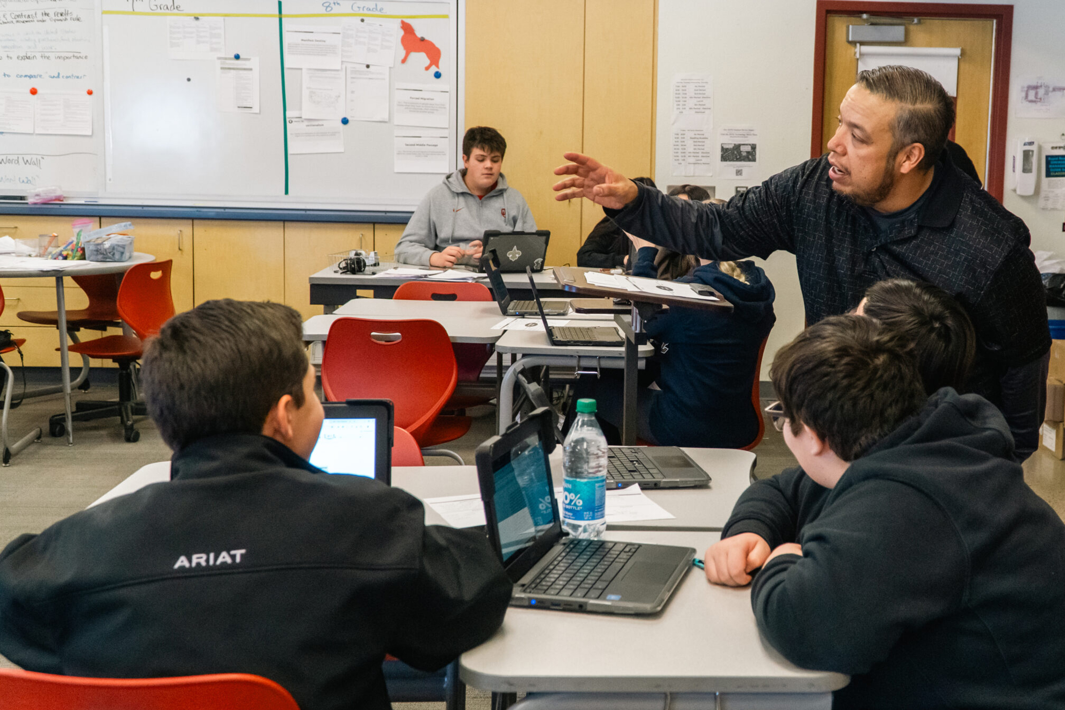 Teacher in classroom with group of students at desks