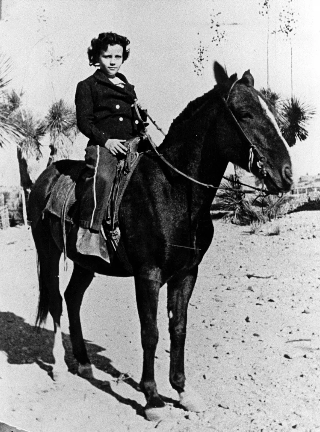 Black-and-white photo of Sandra Day O'Connor as a child on horseback