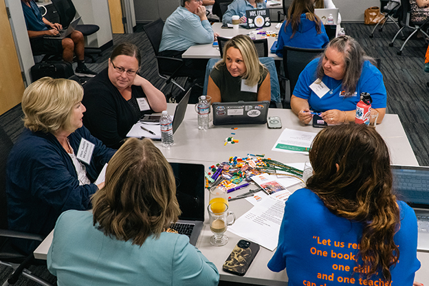 educators in discussion around table